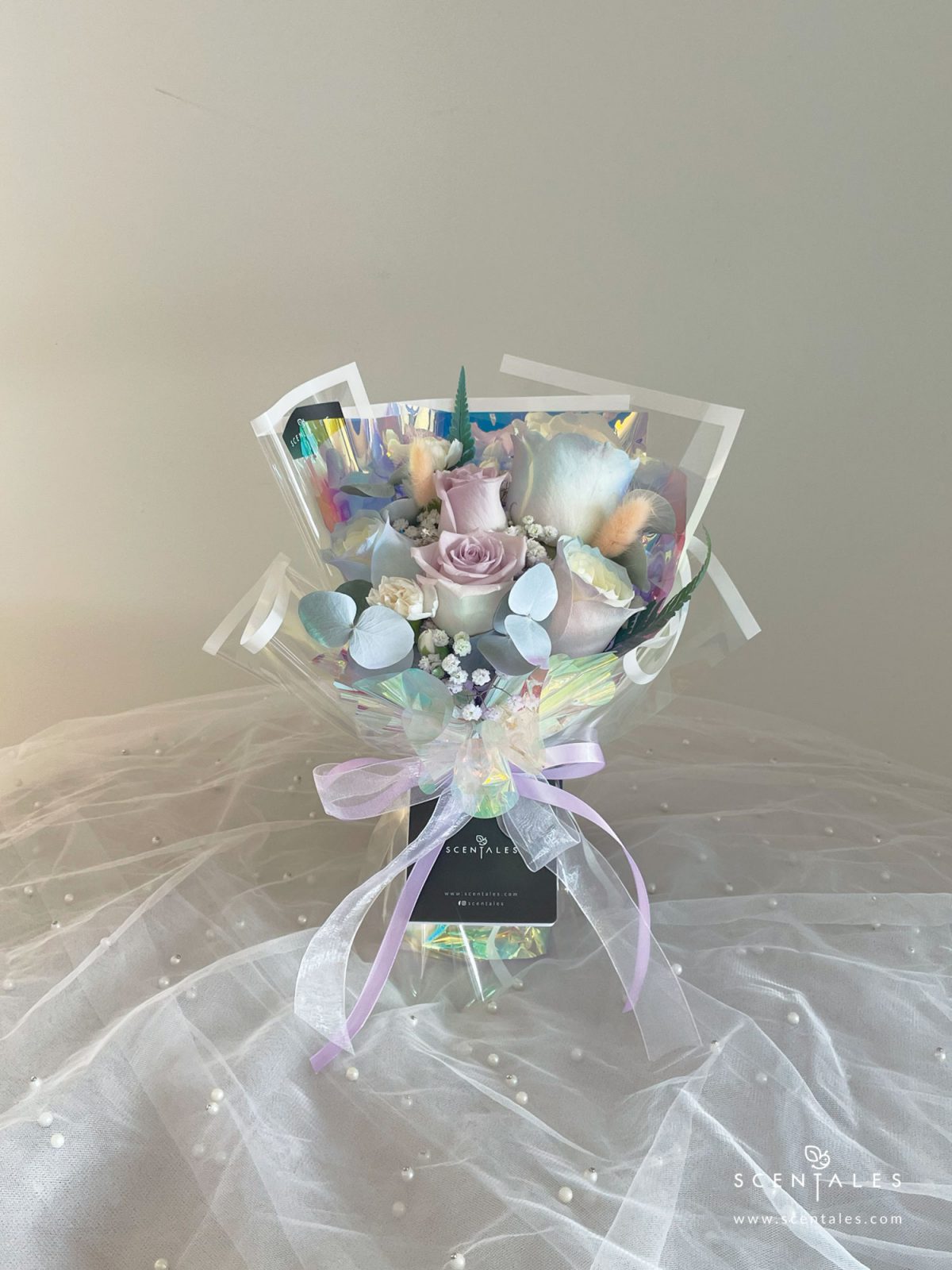 fresh flower bouquet with Pastel color rose, lilac rose, white spray carnation, dried bunny tail, plenty of baby’s breath, eucalyptus and paku leaves