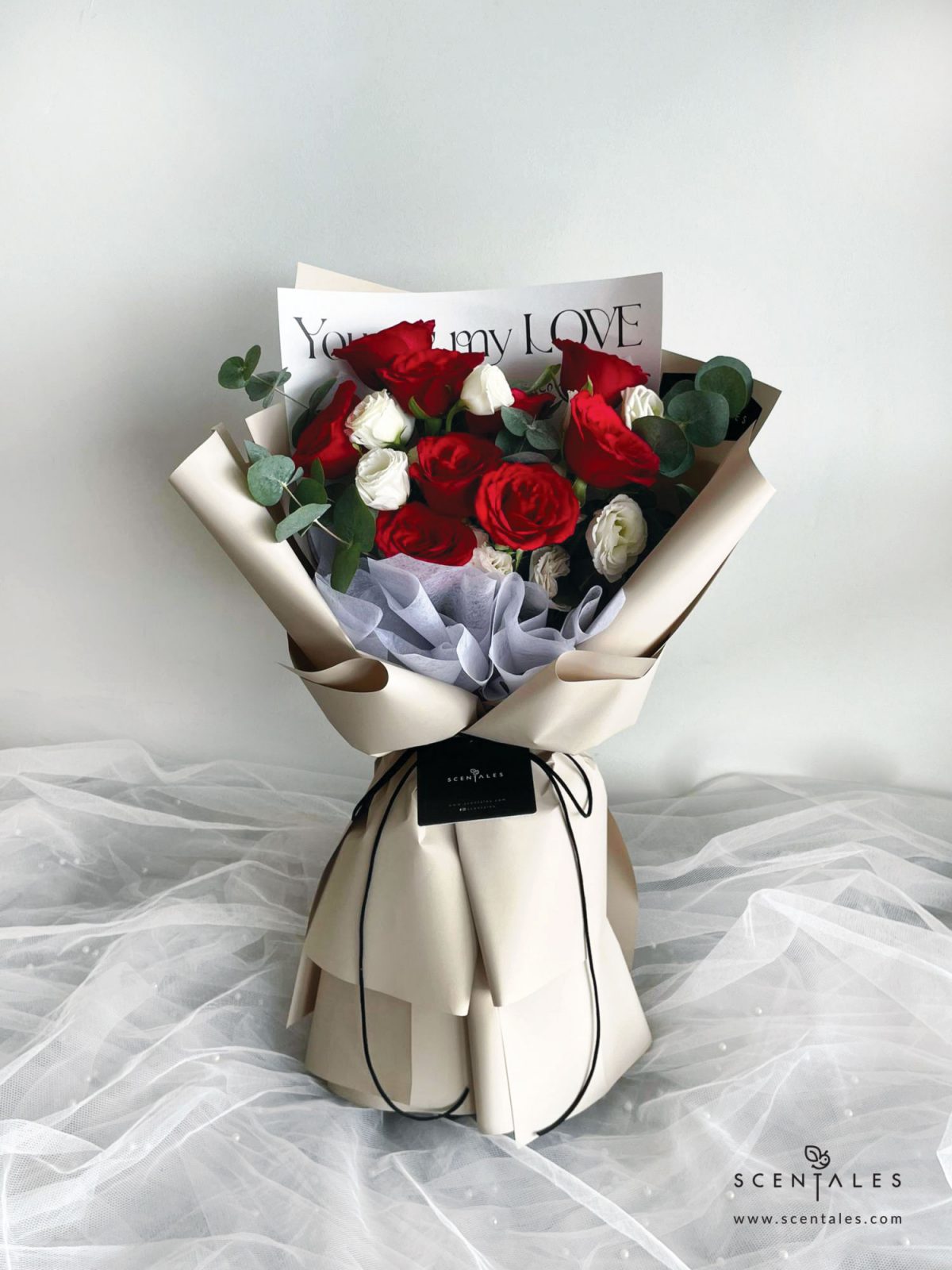 Fresh flower bouquet with red rose, white eustoma and plenty of eucalyptus