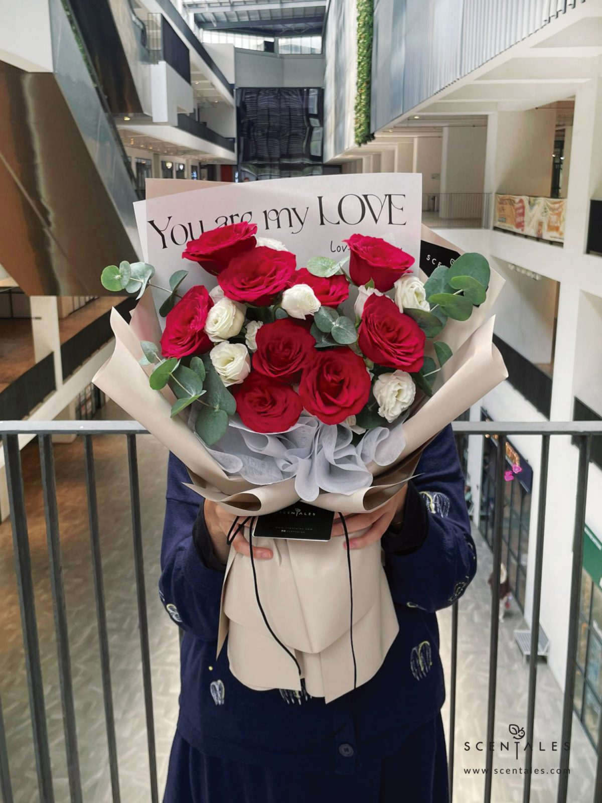 Fresh flower bouquet with red rose, white eustoma and plenty of eucalyptus