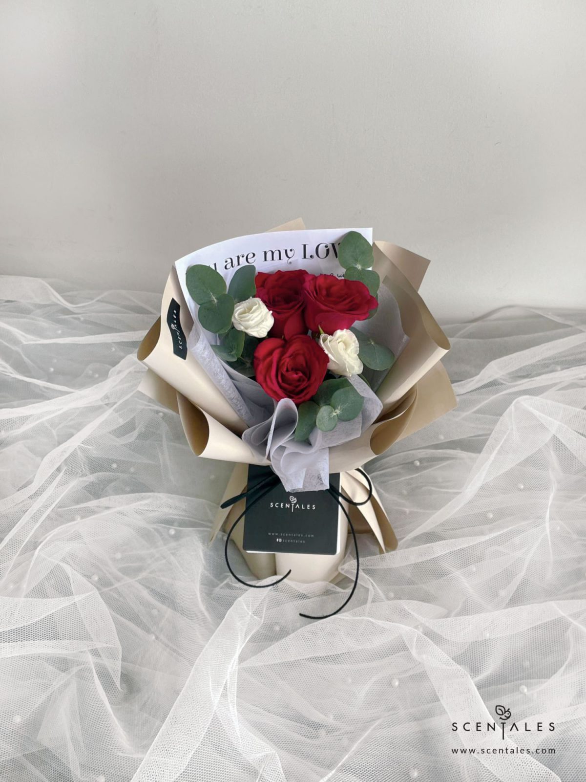 Fresh flower bouquet with red rose, white eustoma and plenty of eucalyptus