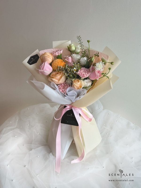 Fresh Flower bouquet with Champagne rose, pink rose, pink carnation, orange ping pong, chamomile, white trachymene buds, white eustoma and plenty of thlaspi