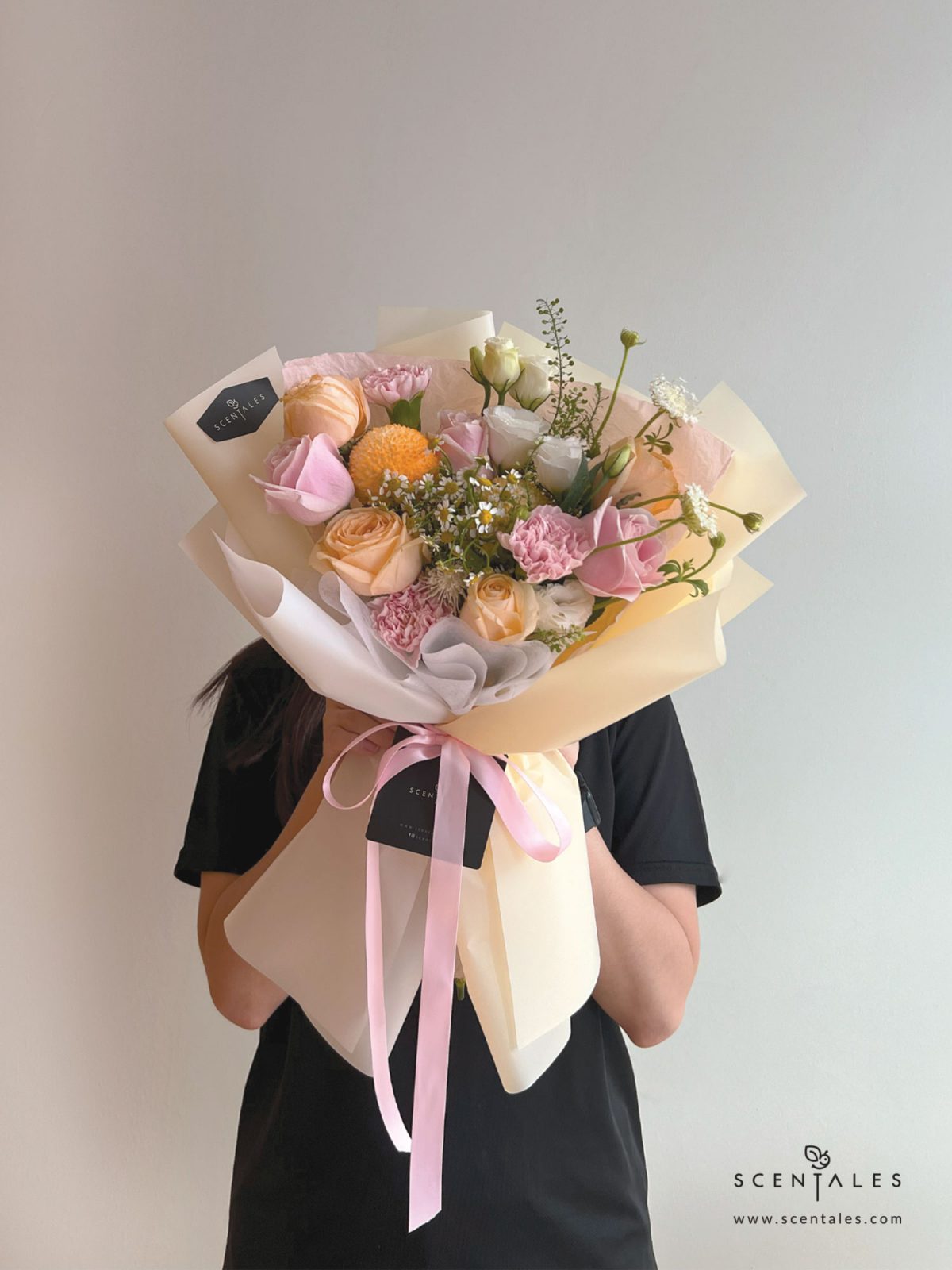 Fresh Flower bouquet with Champagne rose, pink rose, pink carnation, orange ping pong, chamomile, white trachymene buds, white eustoma and plenty of thlaspi