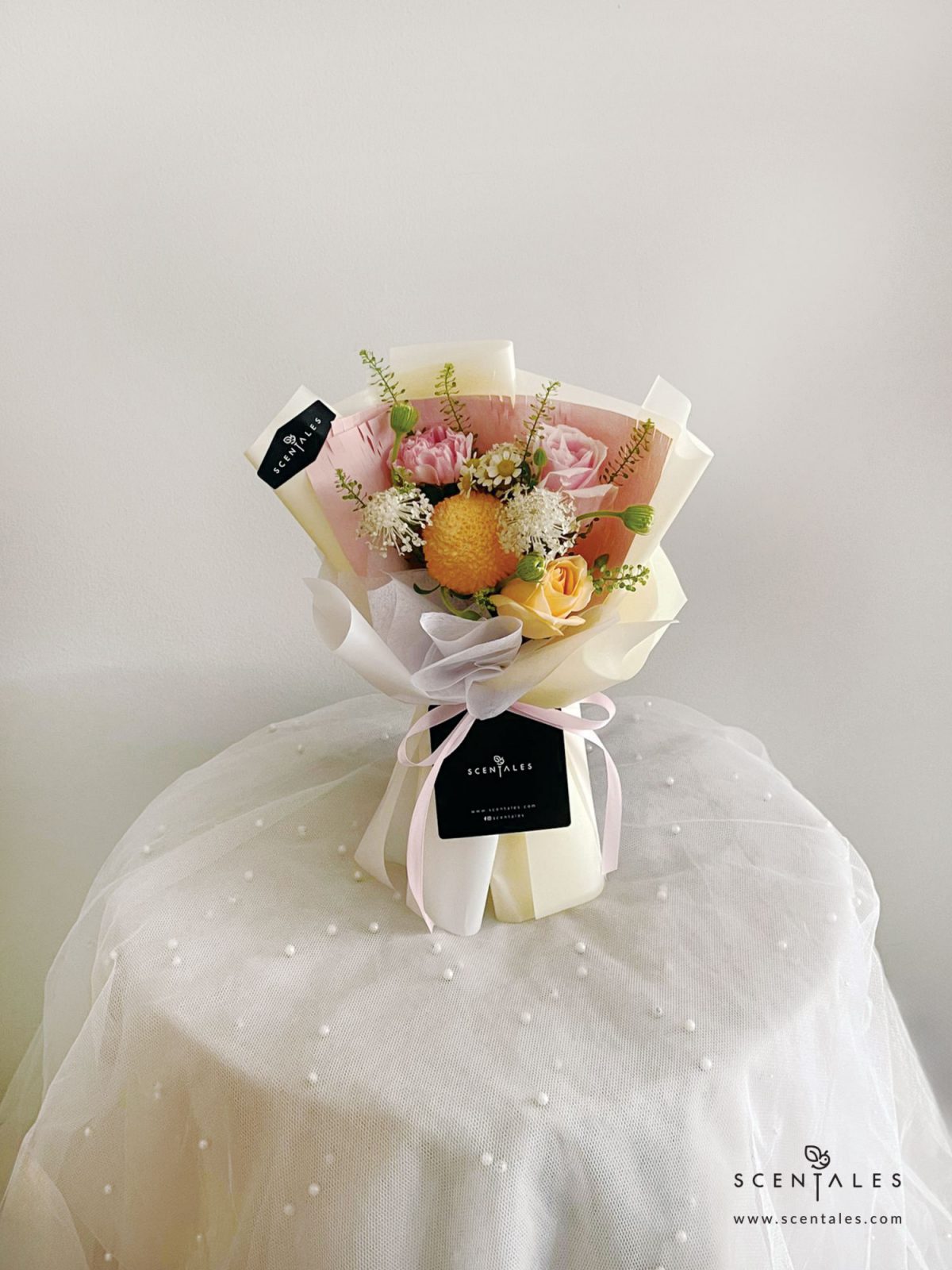 Fresh Flower bouquet with Champagne rose, pink rose, pink carnation, orange ping pong, chamomile, white trachymene buds, white eustoma and plenty of thlaspi