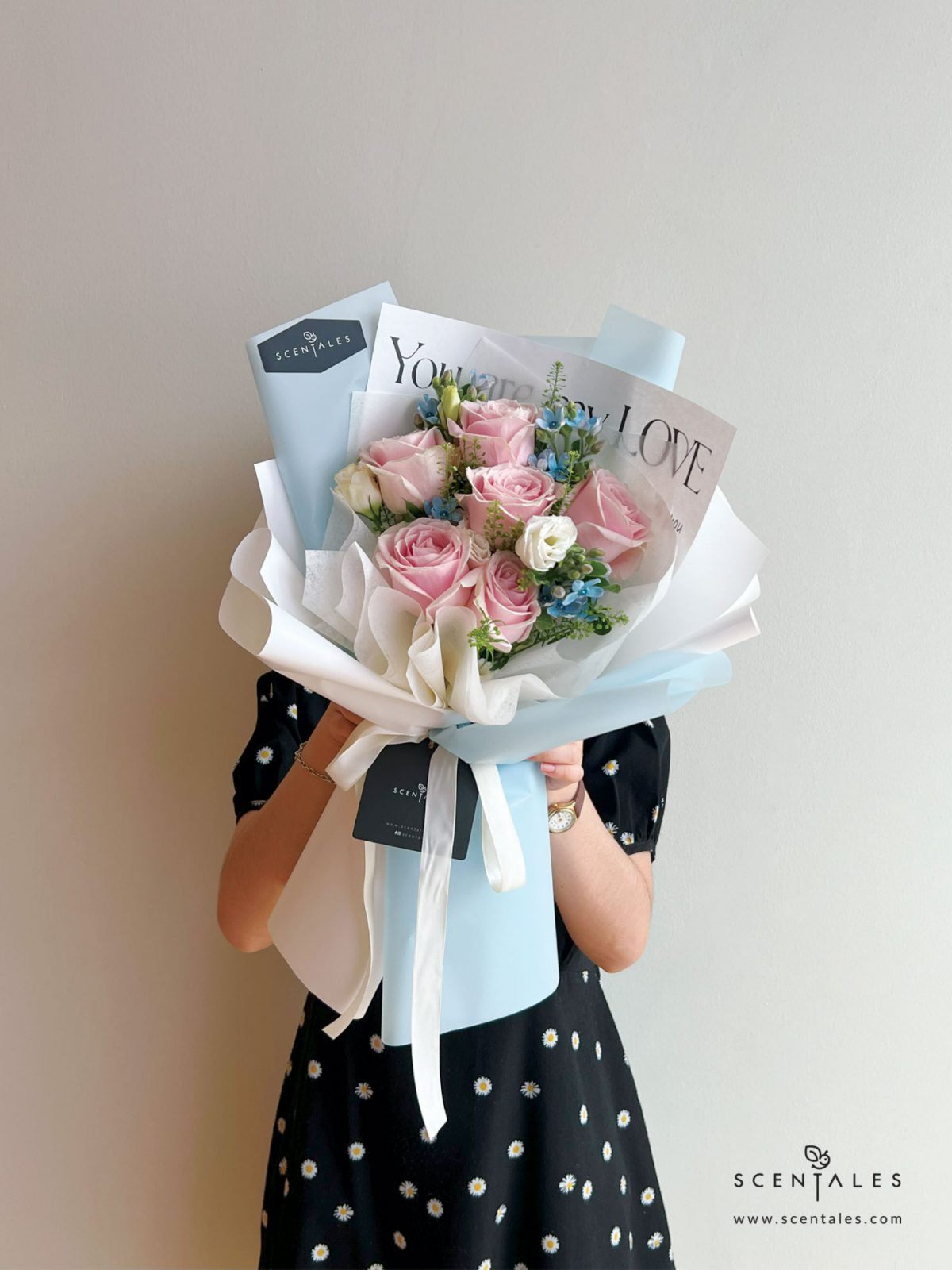 Fresh flower bouquet with Pink rose, white eustoma buds, blue oxypetalum and plenty of thlaspi