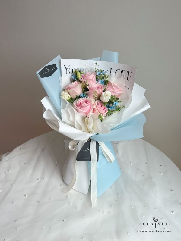 Fresh flower bouquet with Pink rose, white eustoma buds, blue oxypetalum and plenty of thlaspi