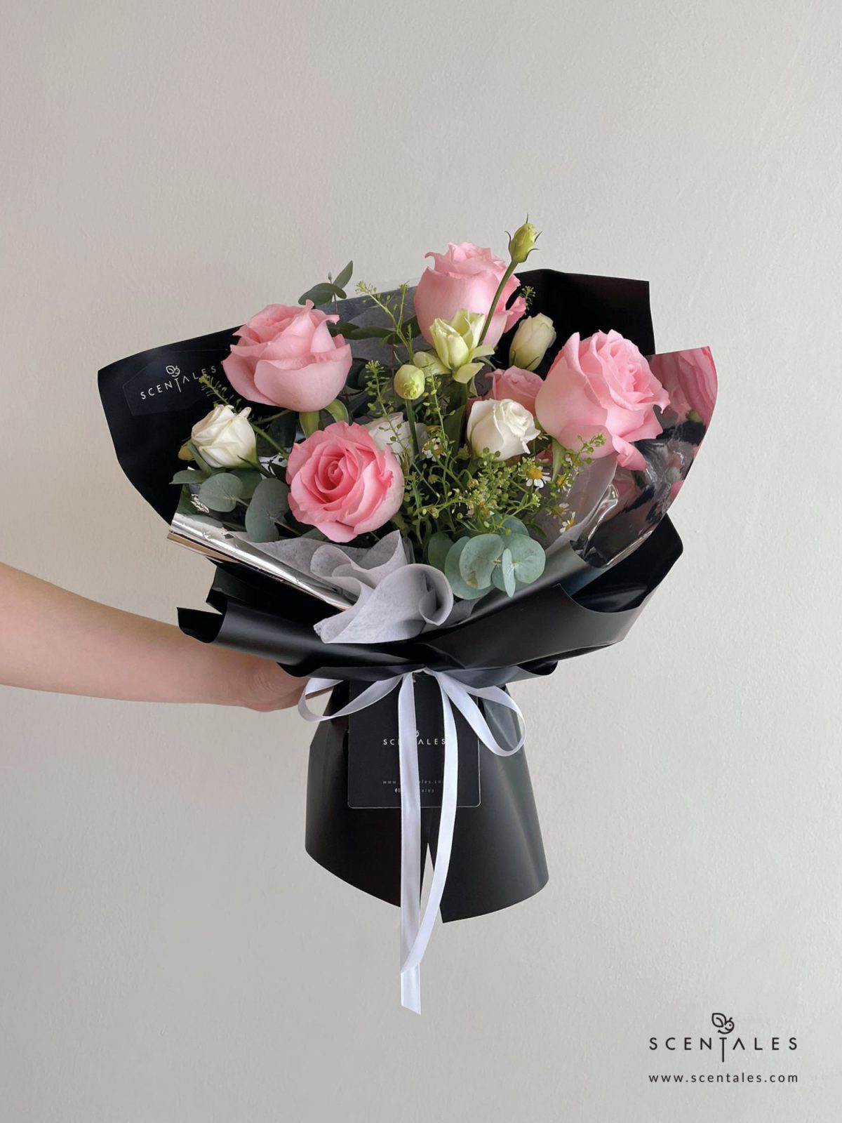 Fresh flower bouquet with Pink rose, white eustoma buds, chamomile, plenty of thlaspi and eucalyptus