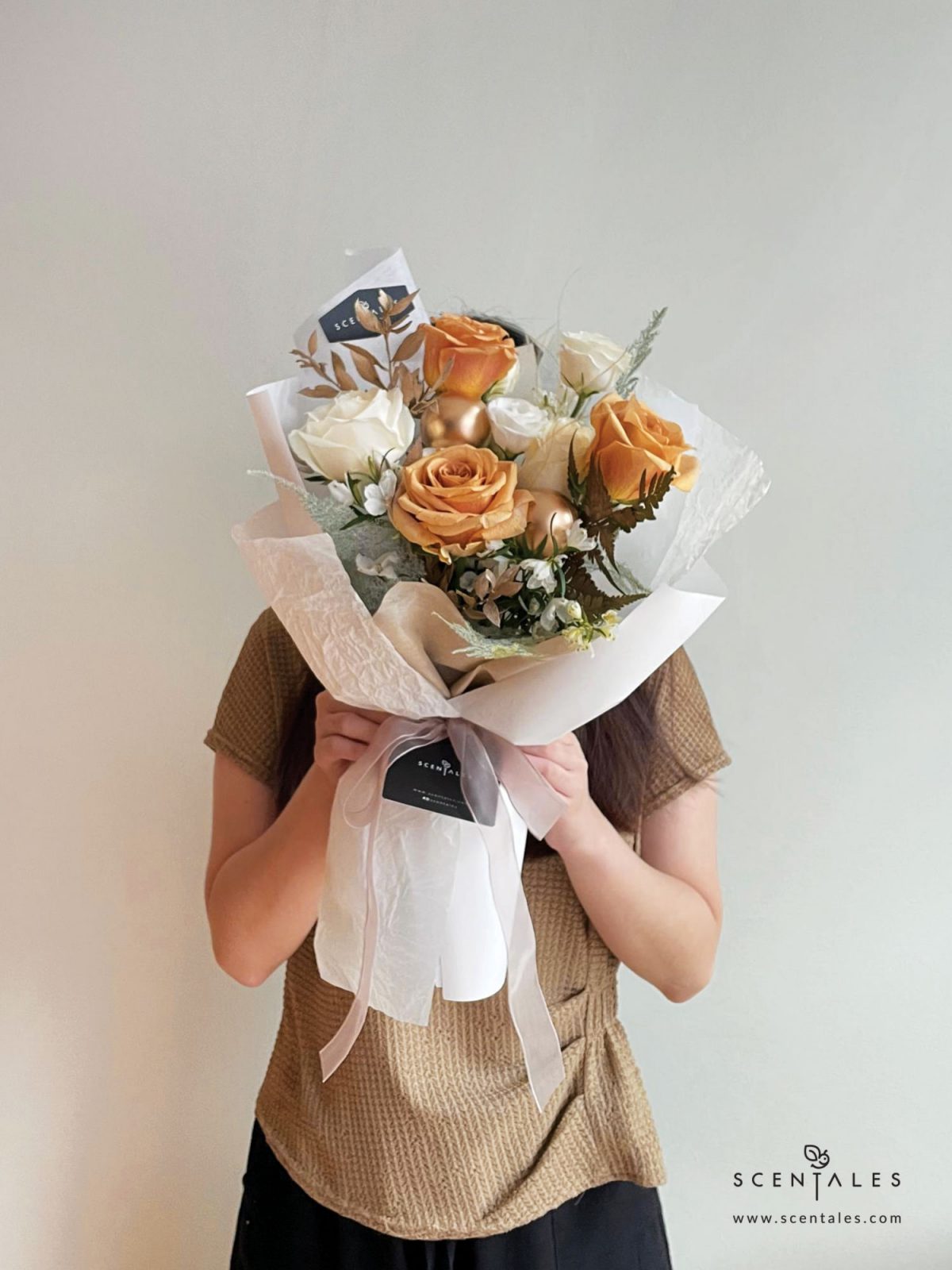 Fresh flower bouquet with Toffee rose, white rose, white eustoma buds, white mini delphinium, paku leaf, gold christmas ball and plenty of asparagus fern, stipa grass and preserved ruscus