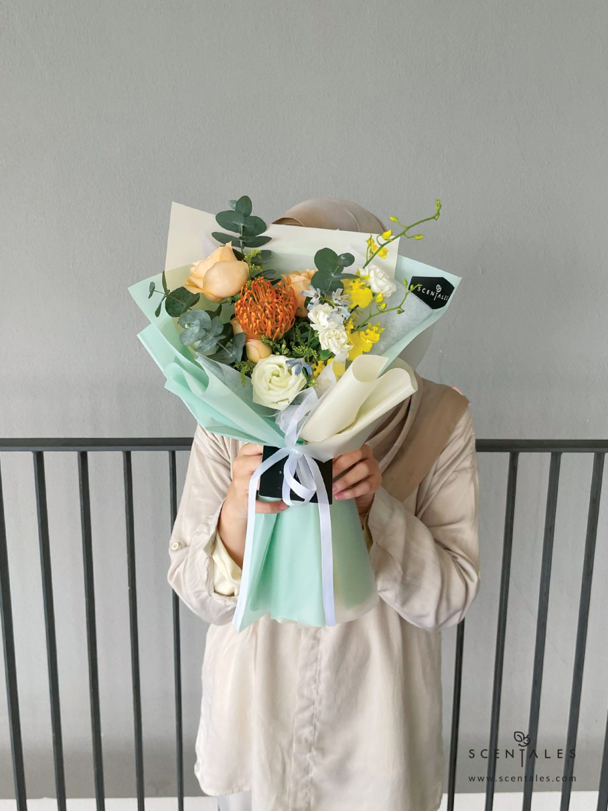 Fresh flower bouquet with Orange leucospermum, champagne rose, champagne spray rose, yellow dancing lady, light blue mini delphinium, white eustoma bud, white spray carnation, yellow peacock and plenty of eucalyptus cinerea