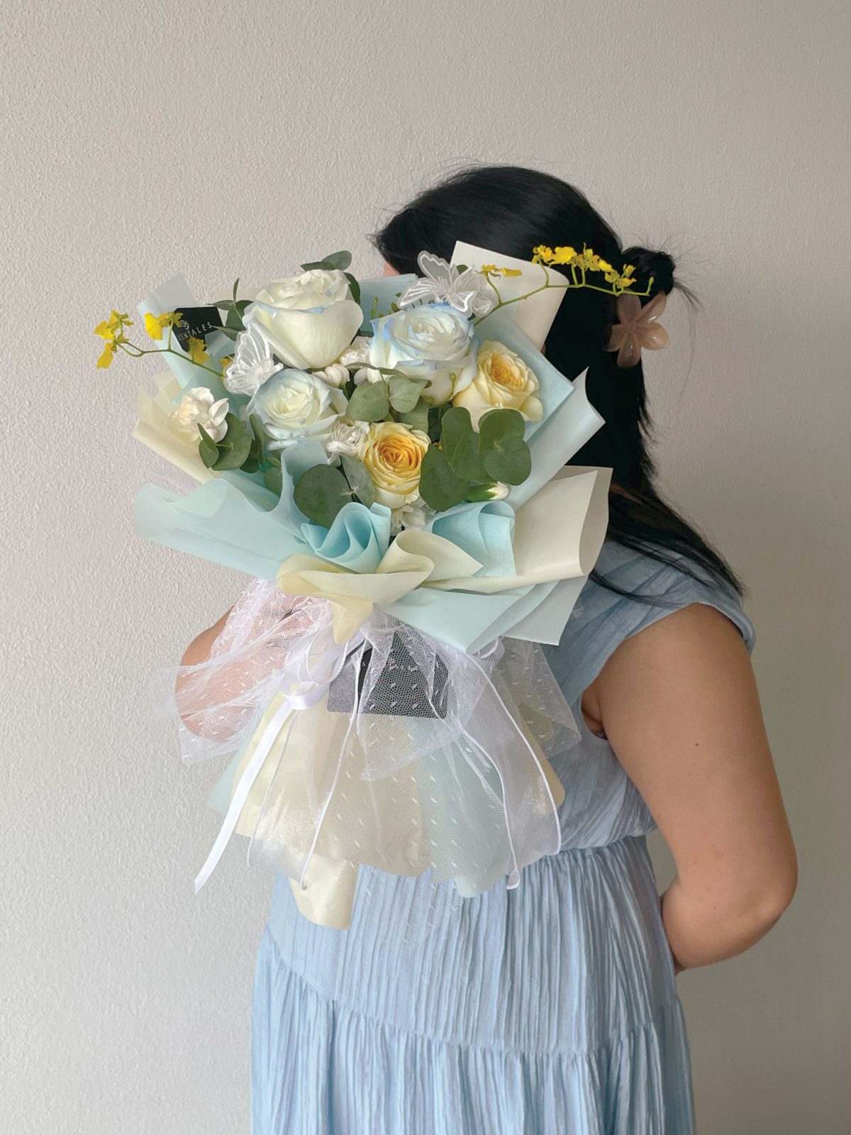 fresh flower bouquet with Gradient rose, cream rose, white spray carnation, yellow dancing lady, butterfly and plenty of eucalyptus cinerea