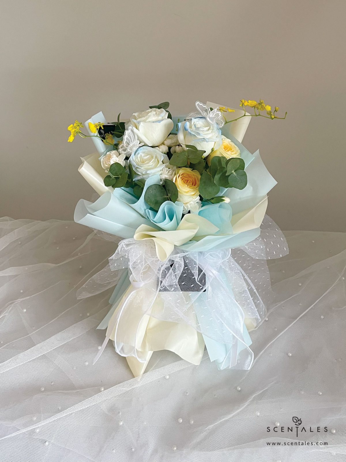 fresh flower bouquet with Gradient rose, cream rose, white spray carnation, yellow dancing lady, butterfly and plenty of eucalyptus cinerea