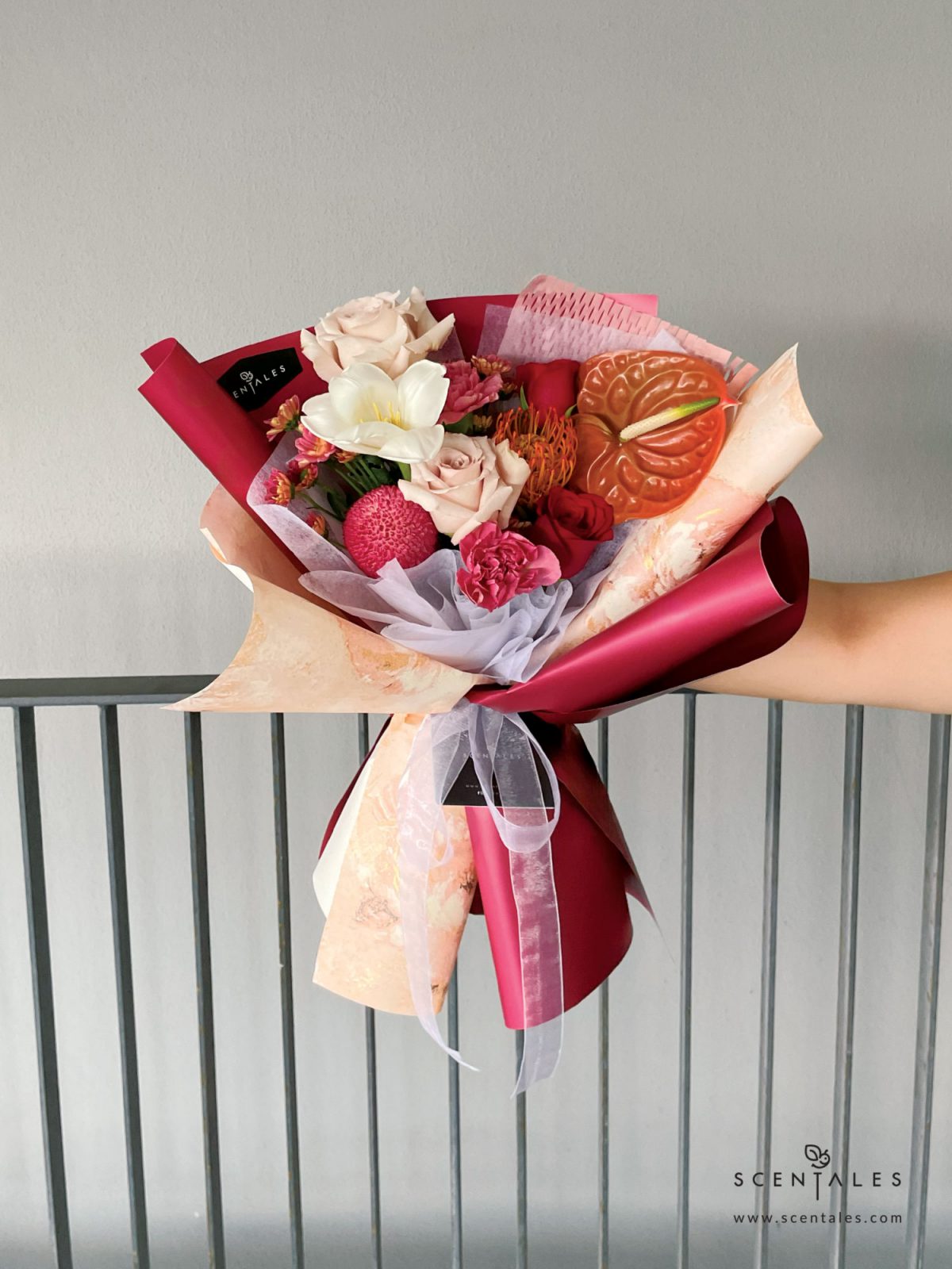 fresh flower with Quicksand rose, red rose, red leucospermum, white tulip, love of cuba carnation, maroon ping pong, anthurium and rossi smokey calimero pom pom