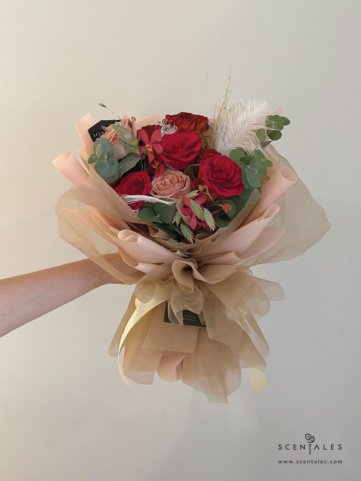 fresh flower bouquet with red rose, cappuccino rose, chocolate spray rose, dried brown pampas, red mokara orchid, preserved white asparagus, chasmanthium grass, white feather and plenty of eucalyptus cinerea