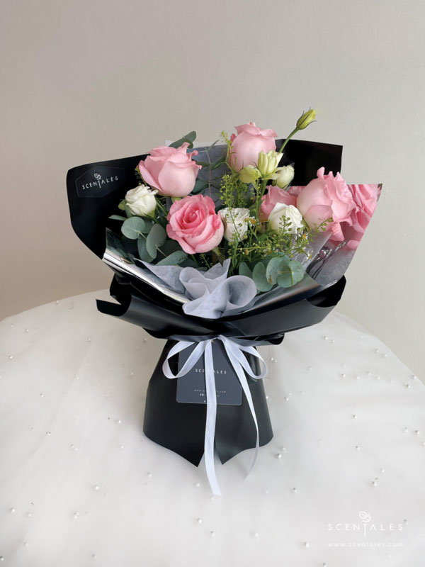 Fresh flower bouquet with Pink rose, white eustoma buds, chamomile, plenty of thlaspi and eucalyptus