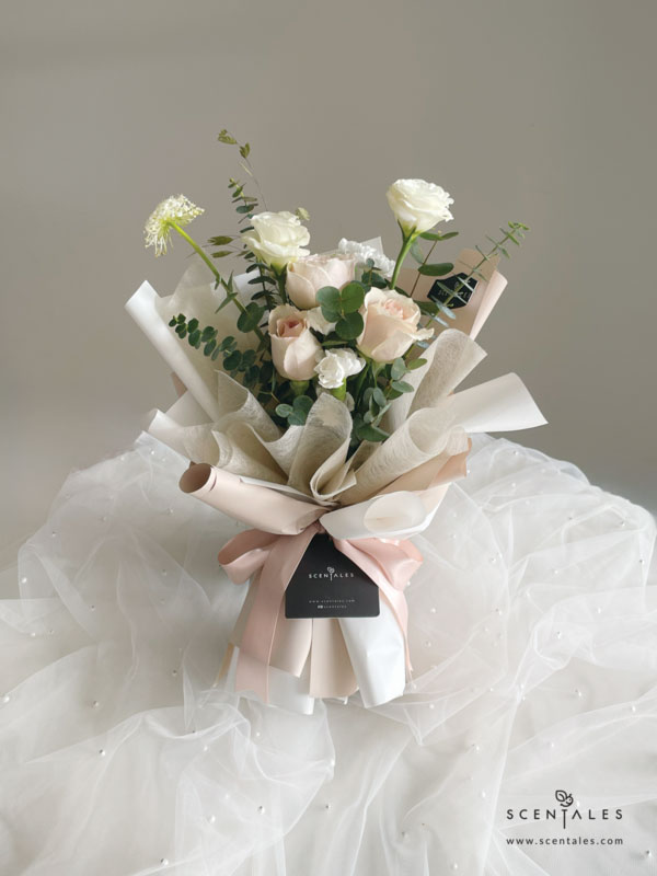 Fresh flower bouquet with Quicksand rose , white eustoma buds, trachymene , white spray carnation, chasmanthium grass and plenty of eucalyptus cinerea