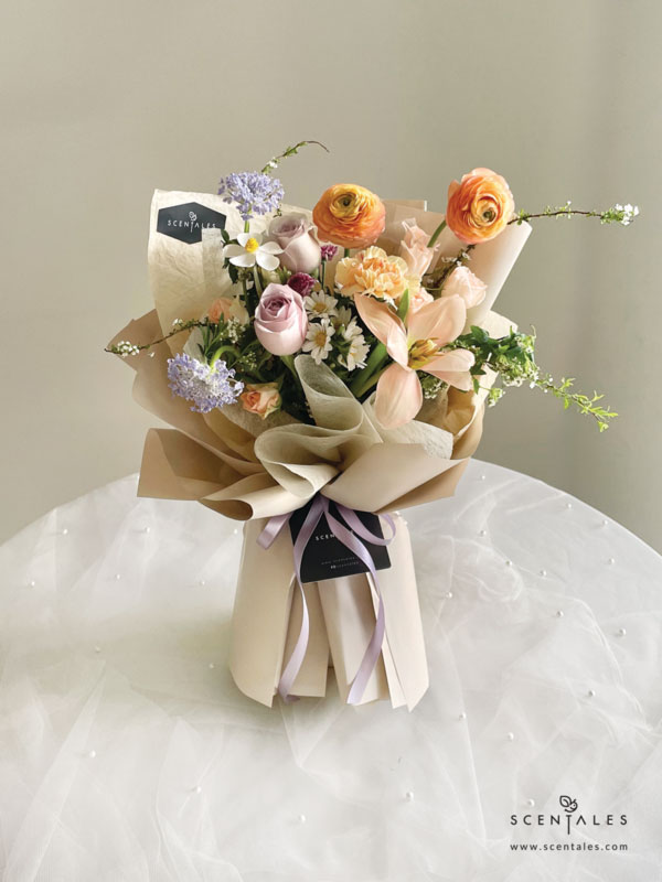 fresh flower with Apricot tulip, light orange ranunculus, champagne carnation, light orange spray rose, lilac rose, white hana, blue trachymene, light purple calimero, preserved white violet and plenty of spiraea